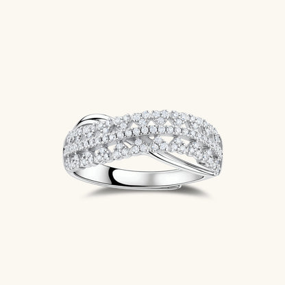 Sterling silver crossover ring with pavé-set moissanite stones creating an elegant infinity design on neutral background