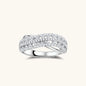 Sterling silver crossover ring with pavé-set moissanite stones creating an elegant infinity design on neutral background