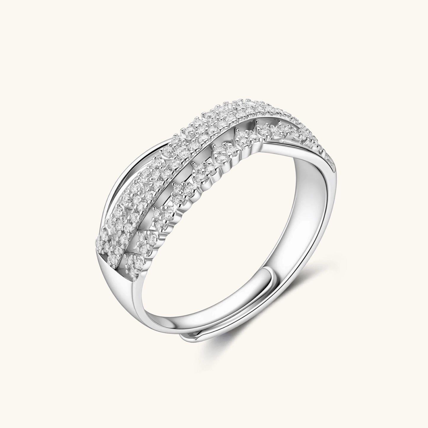 Sterling silver crossover ring with pavé-set moissanite stones creating an elegant infinity design on neutral background