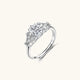 Sterling silver ring with oval moissanite center stone surrounded by smaller accent stones in ornate setting