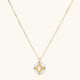 Gold-plated necklace with circular white enamel pendant featuring central zirconia stone and ornate decorative details